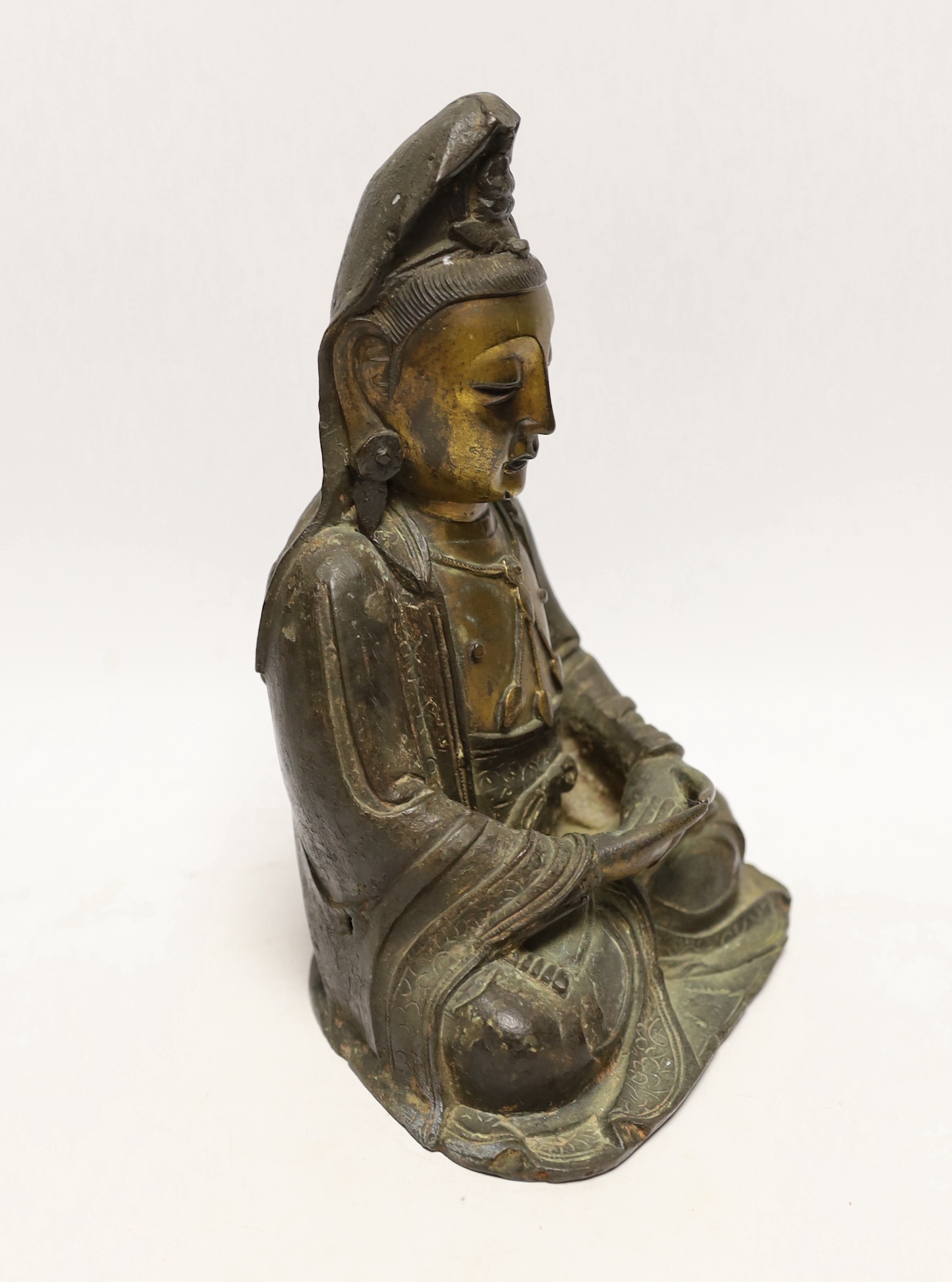 A Chinese Ming gilt bronze figure of Xi Wangmu, Queen Mother of the West, late 16th / early 17th century, Provenance: bought from the 50th Chelsea Antiques Fair, R & D Coombes, 1980, 24cm high